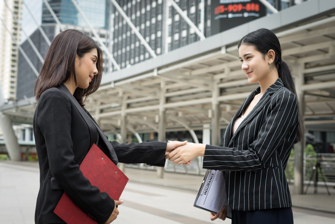 Two businesswomen shaking hands
