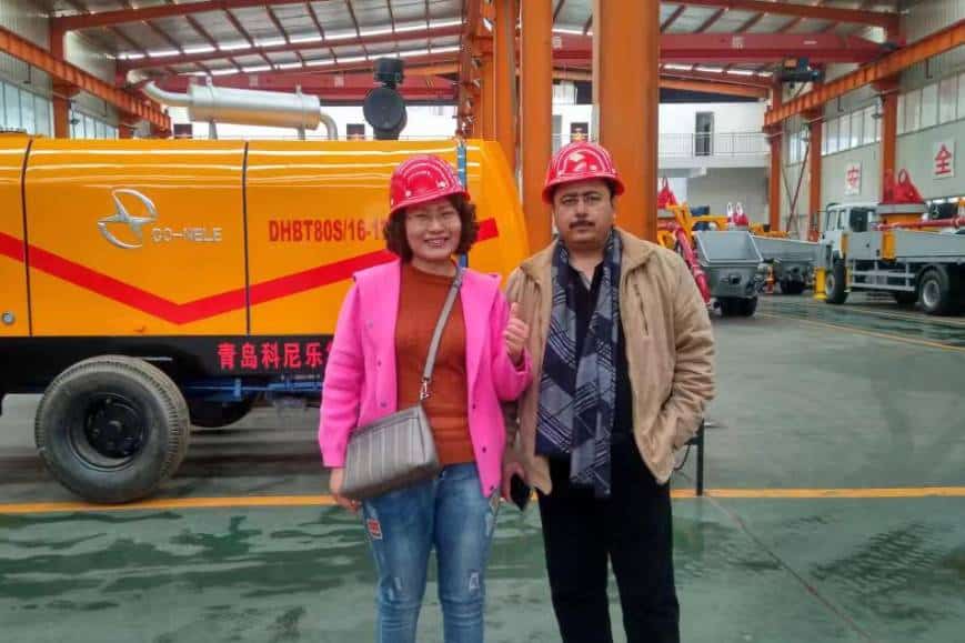 Two CAMAL employees wearing safety helmets conducting on-site inspection